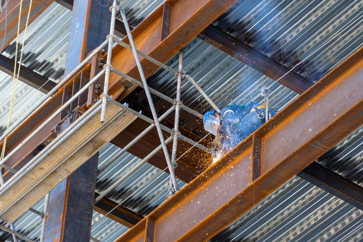 low-angle-shot-of-a-male-welding-with-sparks-on-a-2023-11-27-04-55-54-utc